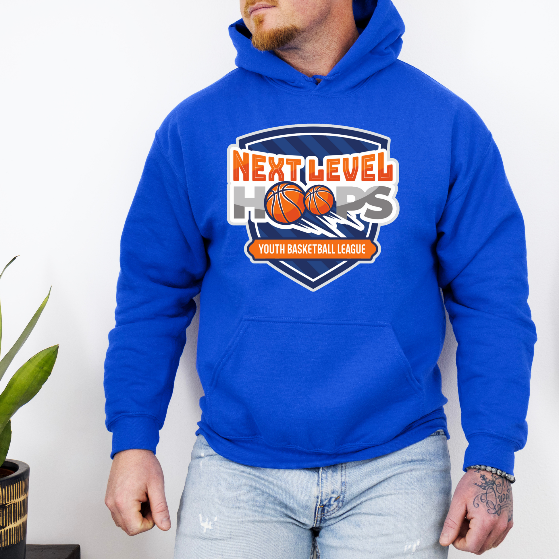 Person wearing a blue hoodie with 'Next Level Hoops' logo